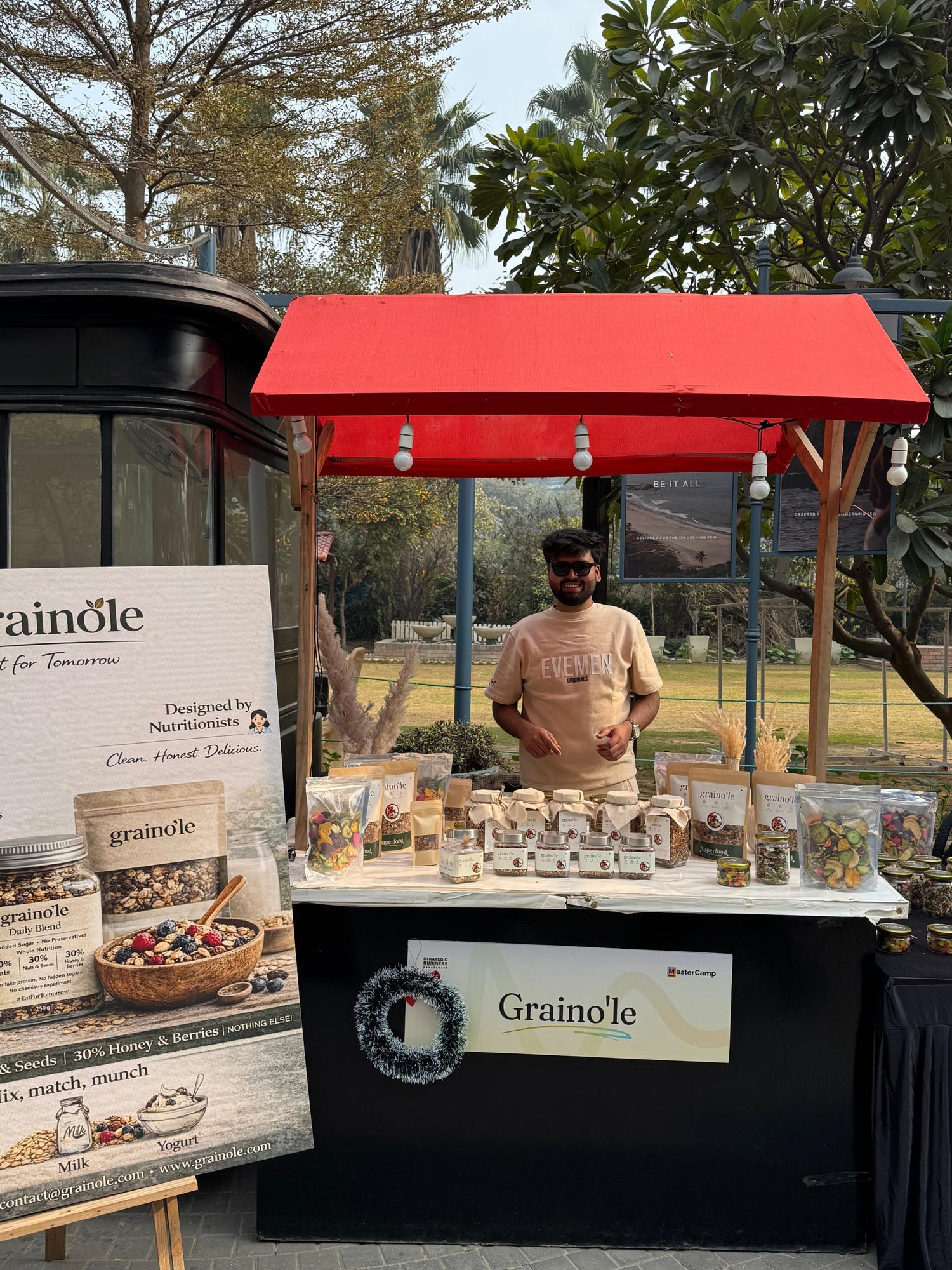 Grainole stall with products and branding at an outdoor event.
